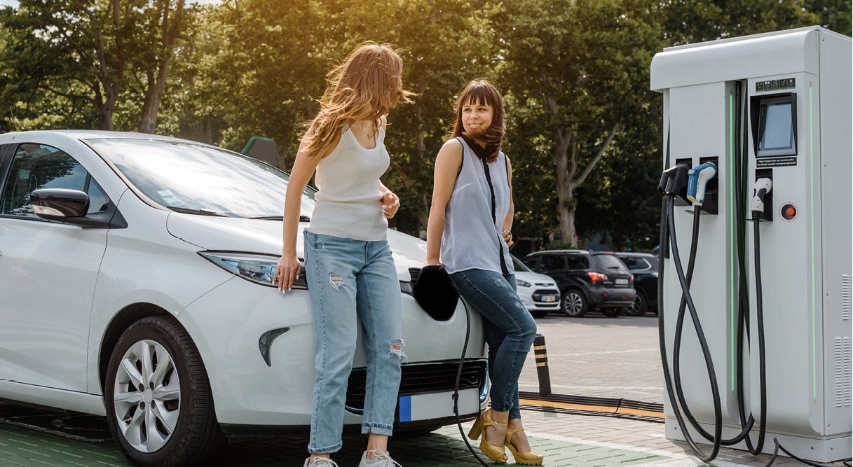 Young women fast charging their EV