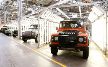 Land Rover Defender automobiles sit in a final inspection area at Tata Motors Ltd.'s Jaguar Land Rover vehicle manufacturing plant in Solihull, U.K., on Wednesday, July, 15, 2015. Jaguar Land Rover, the U.K. luxury-car unit of Tata Motors Ltd., cut its sales targets and prices in China amid slowing demand in the world's largest auto market. Photographer: Chris Ratcliffe/Bloomberg