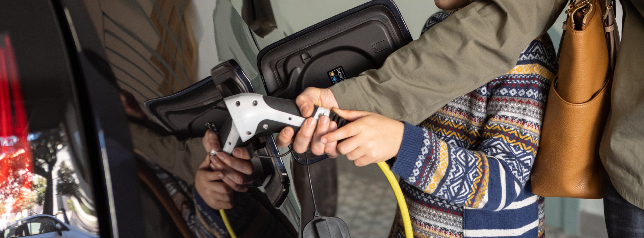Young family charging their electric vehicle