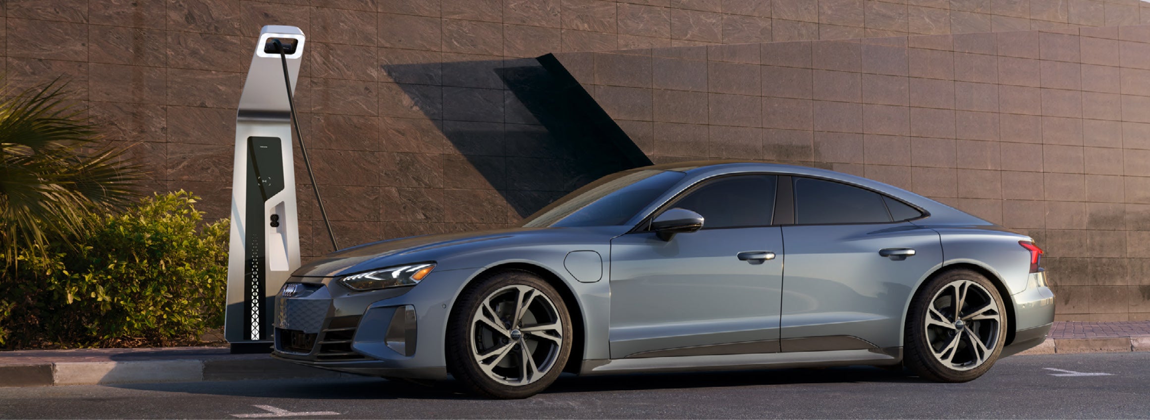 Audi 2023 e-tron GT Parked and charging at a fast charge station